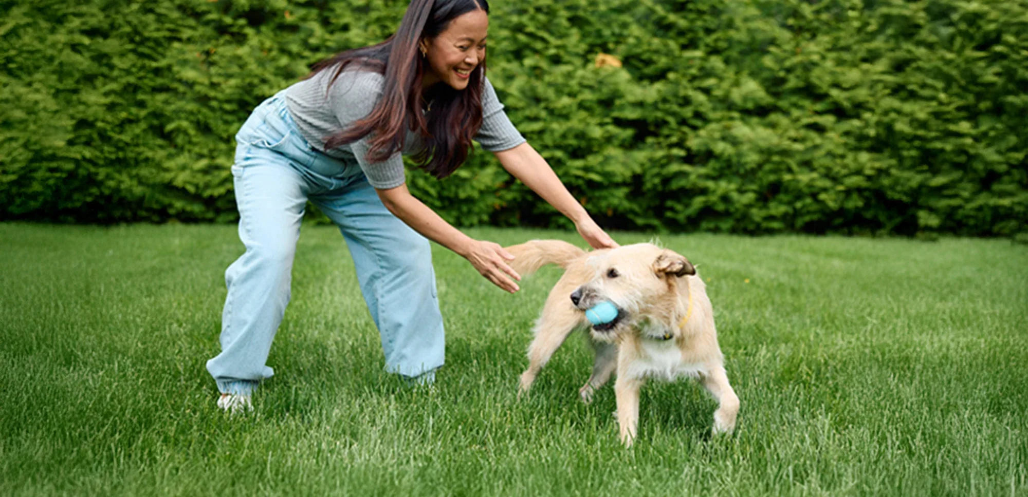 Female playing with dog outside