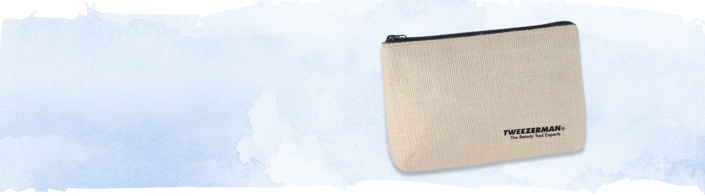 A textured beige zipper pouch with black trim and the TWEEZERMAN logo printed in black on the front, set against a light blue watercolor background.
