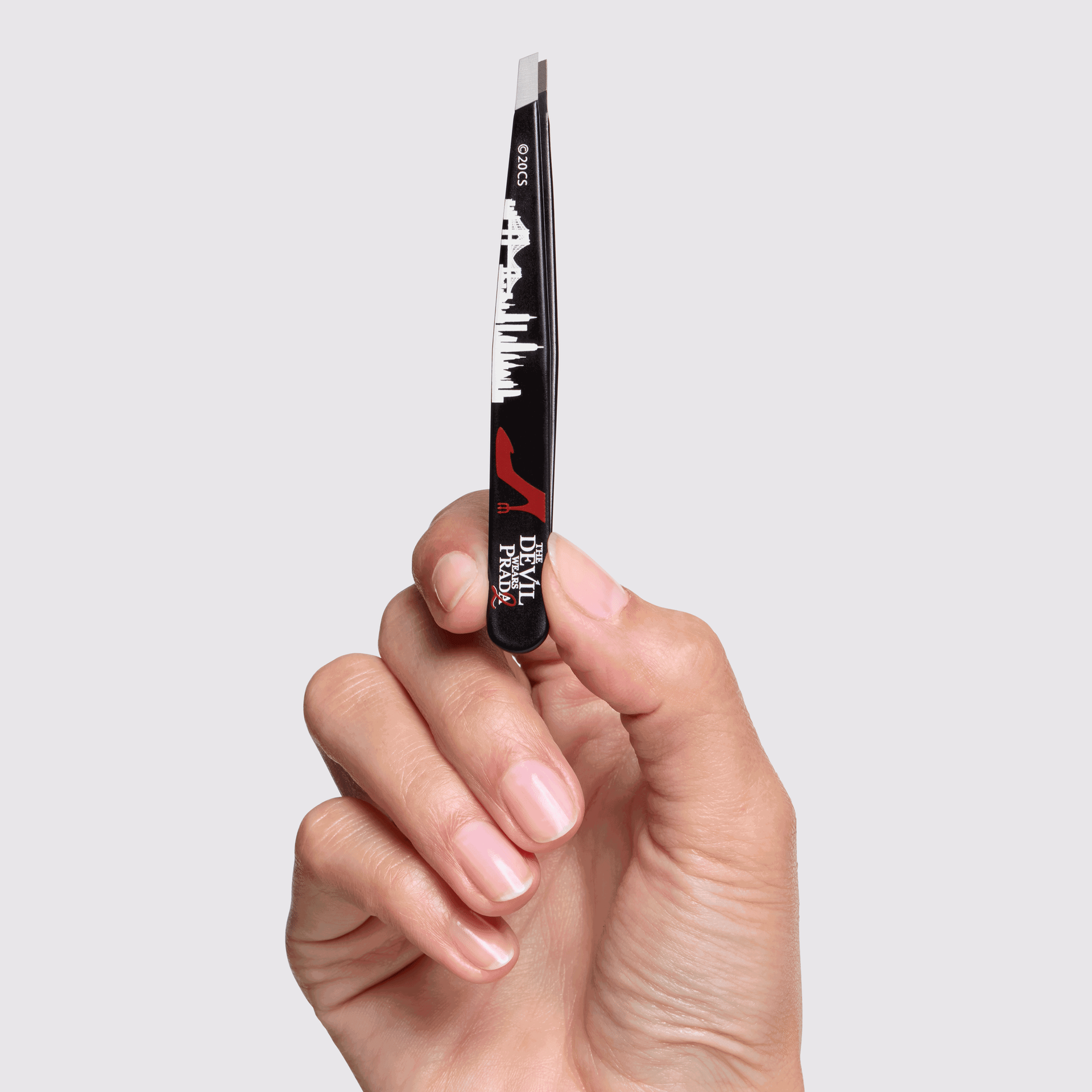 Model holding The Devil Wears Prada 2 Slant Tweezer
