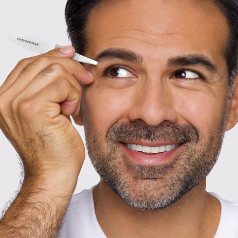 Male Model using the Wide Grip Slant Tweezer to tweeze brows
