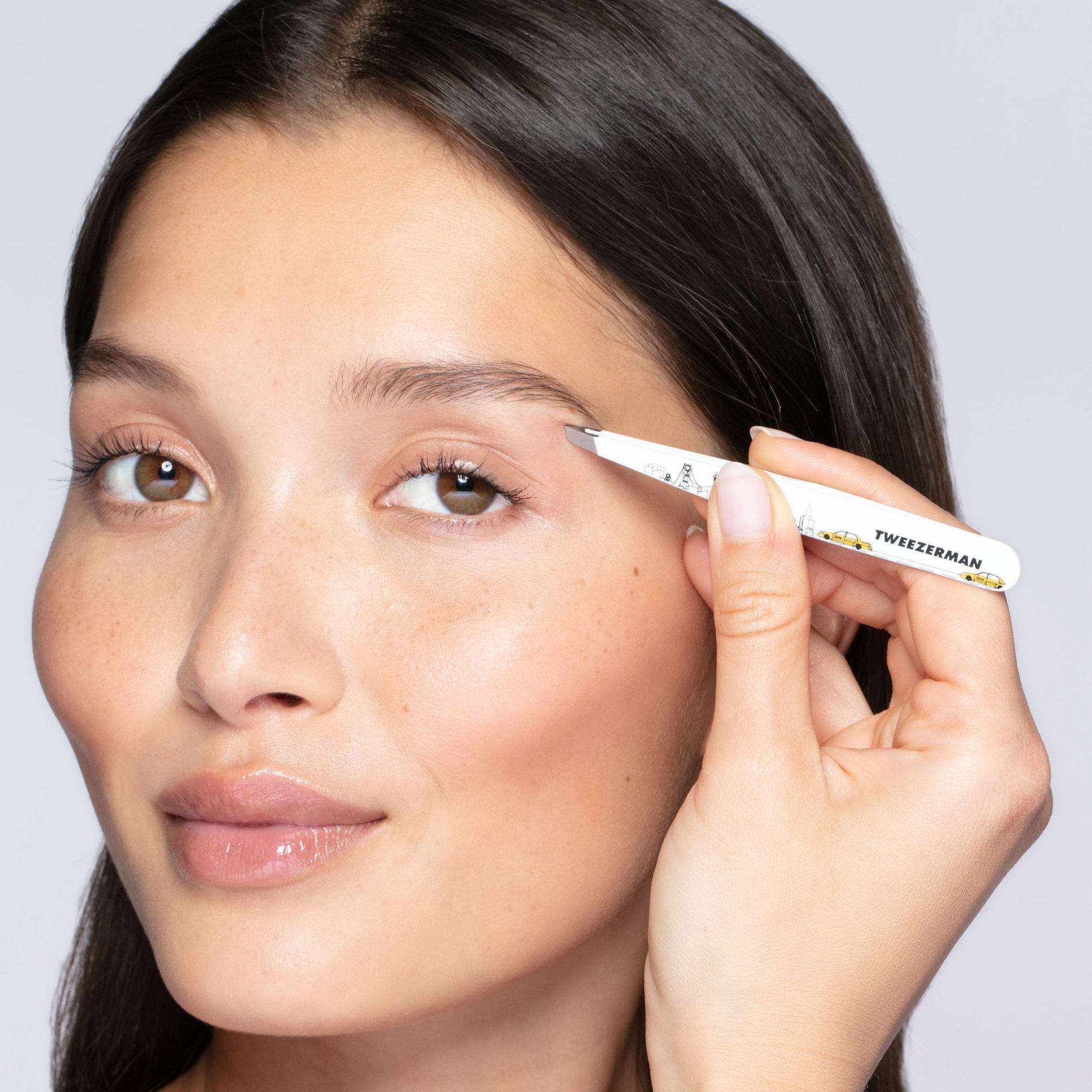 Model holding and using 40th Birthday NYC City Skyline Slant Tweezer