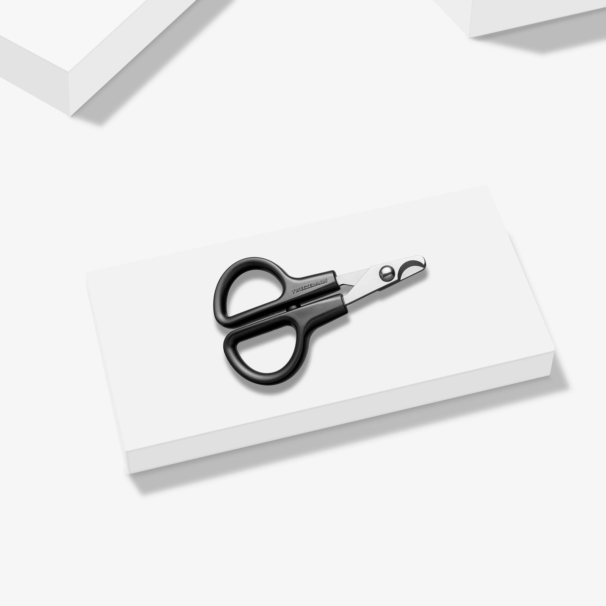 Extra Small Precision Nail Clipper placed on a white block tray