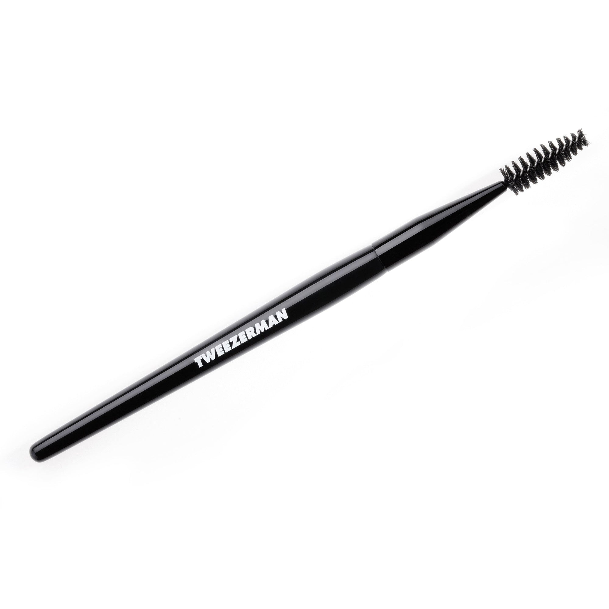 A black Tweezerman brow and lash brush with a white logo on the handle.