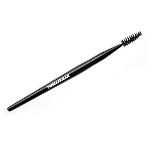 A black Tweezerman brow and lash brush with a white logo on the handle.